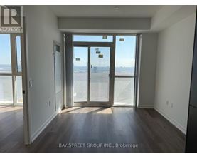 A room with a view of the beach through the sliding glass doors.