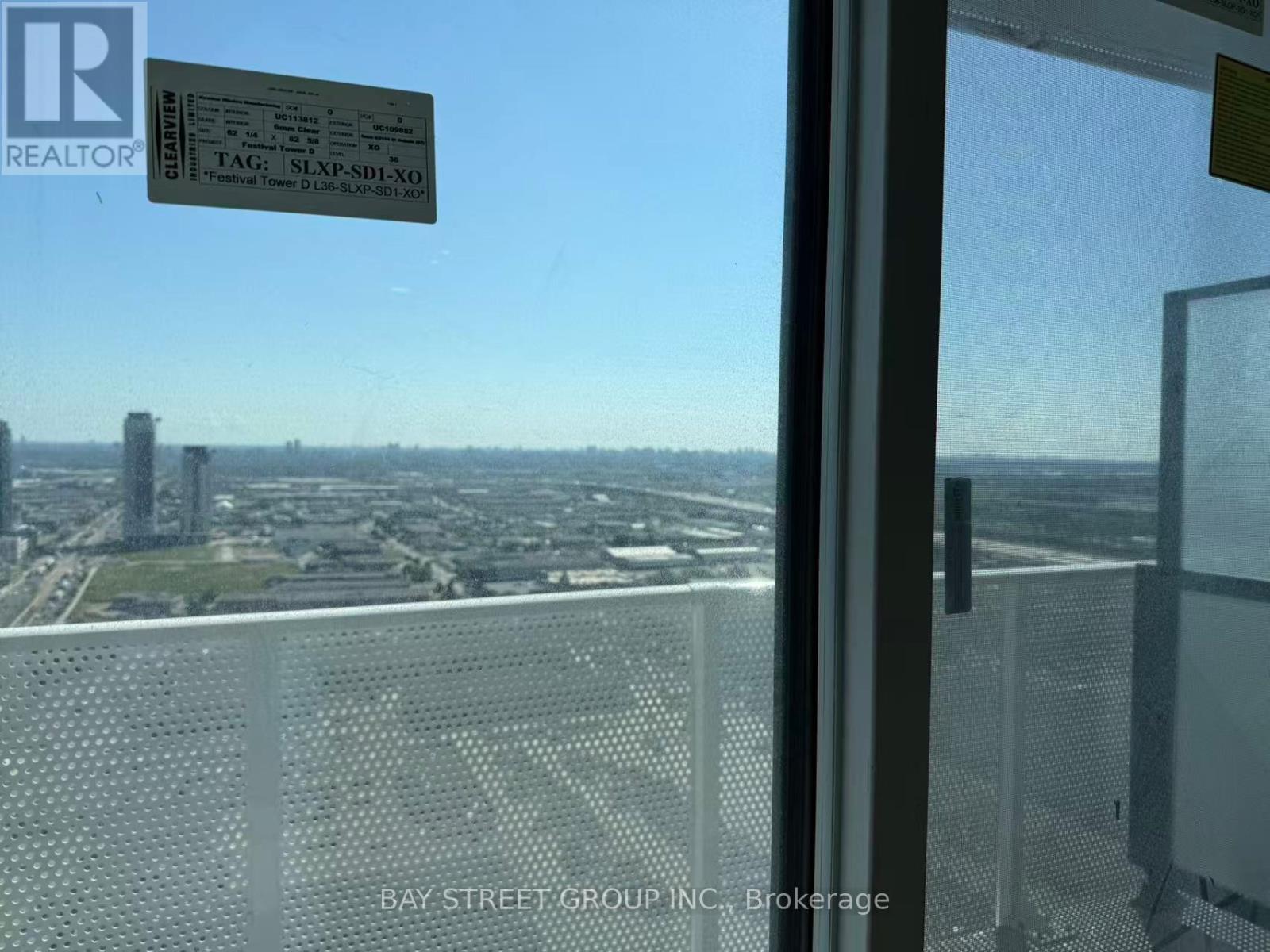 A view from a high-rise window showing a cityscape below.
