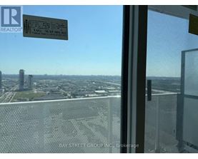 A view from a high-rise window showing a cityscape below.