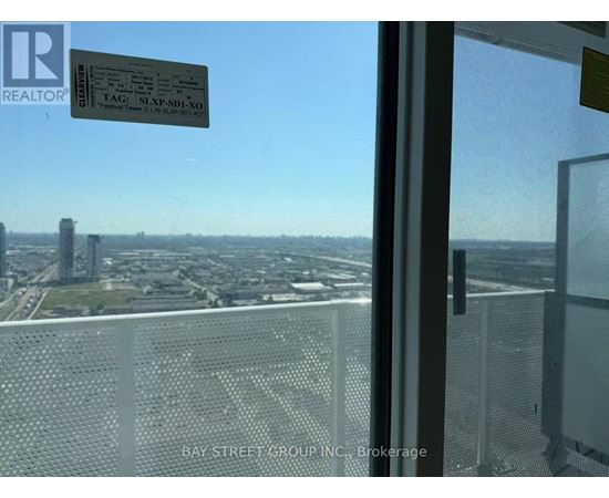 A view from a high-rise window showing a cityscape below.