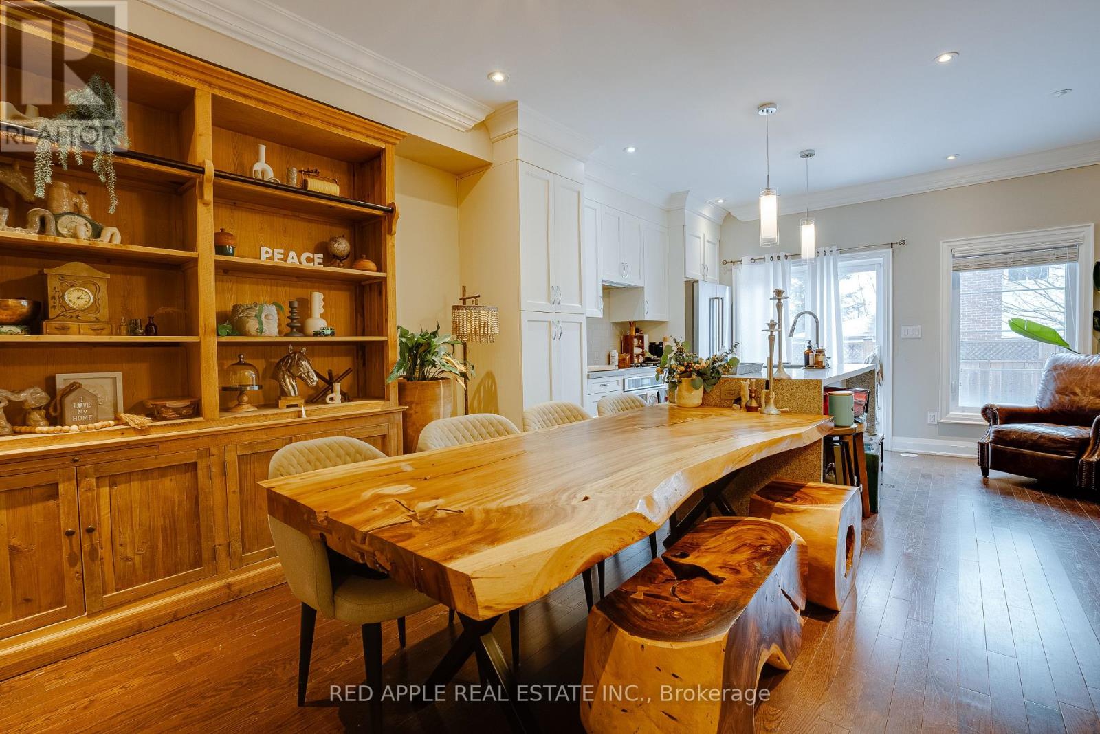 A dining room with a wooden table and chairs.