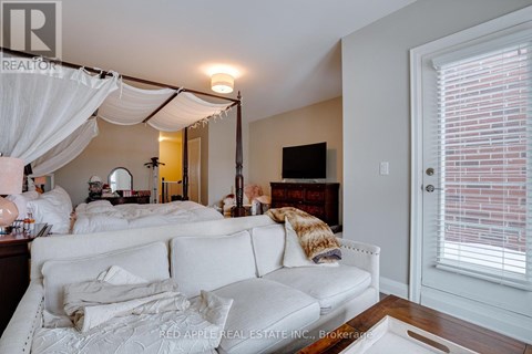 A living room with a white couch and a television.