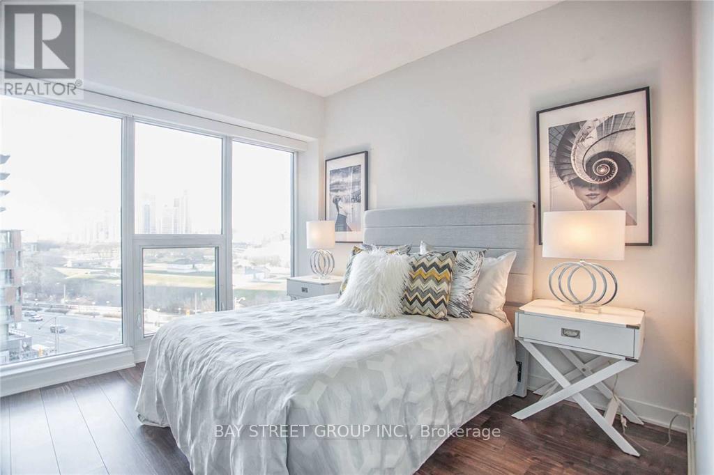 A bedroom with a large bed and a view of the city.