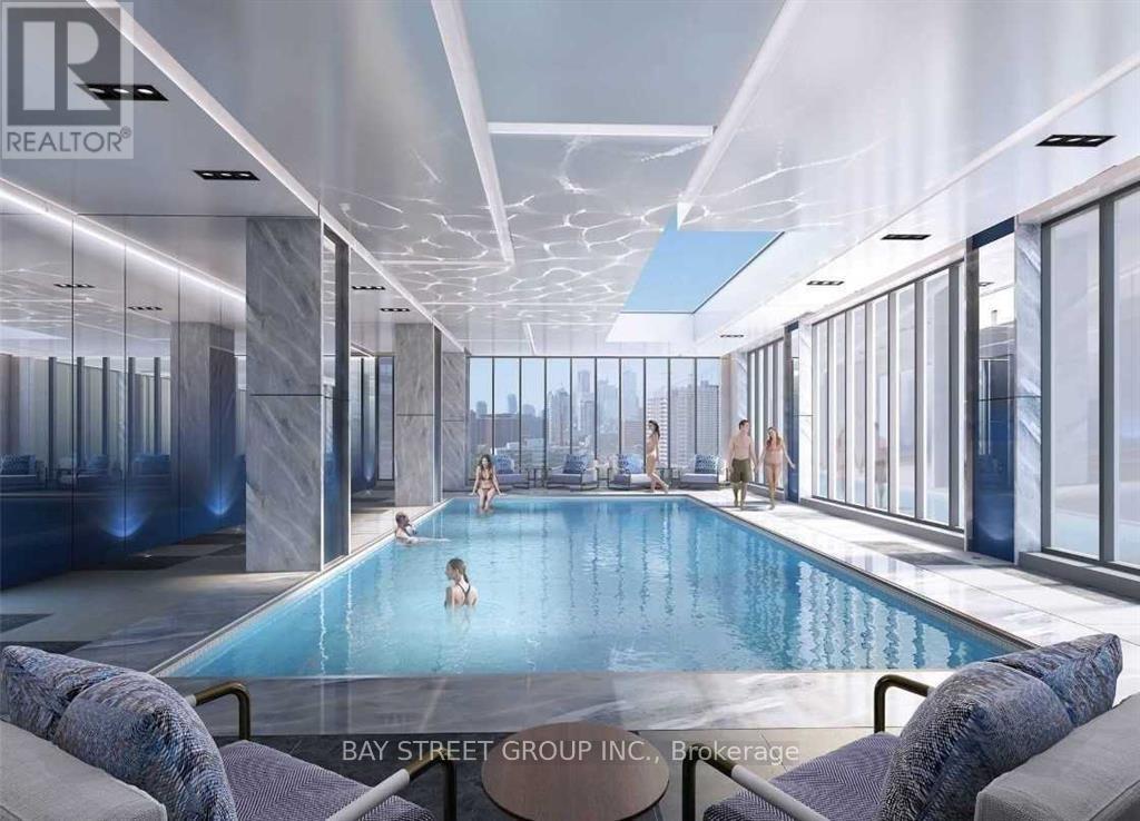 A large indoor swimming pool with people in it.