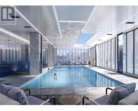A large indoor swimming pool with people in it.