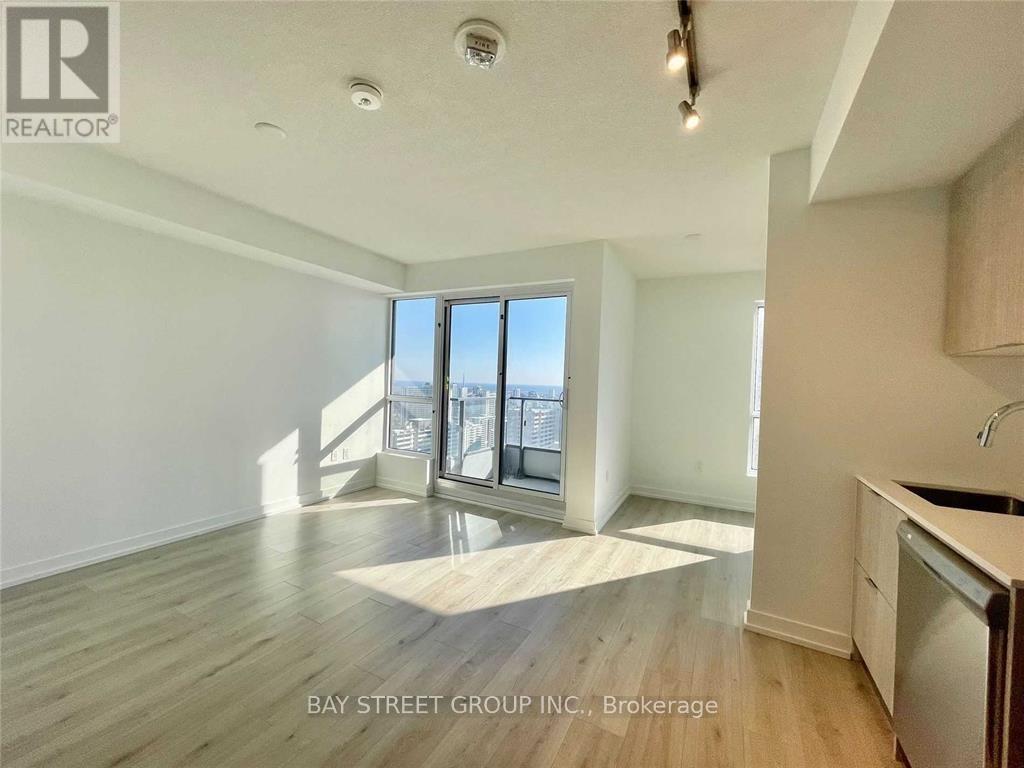 A spacious room with a view of the city through the windows.