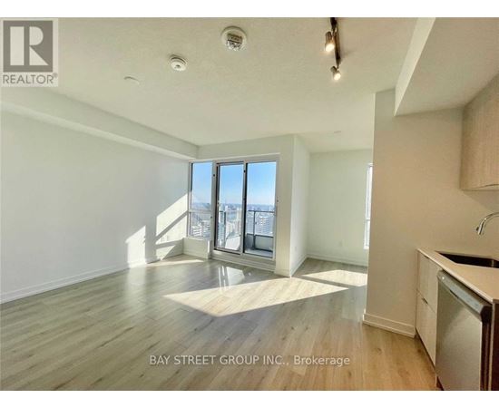A spacious room with a view of the city through the windows.