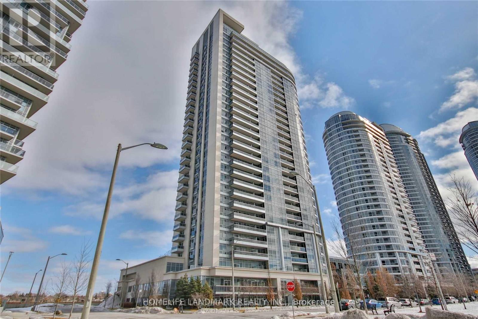 A tall building with a sign that reads "HOMELIFE LANDMARK REALTY INC. JOSTENBACH" in front of it.