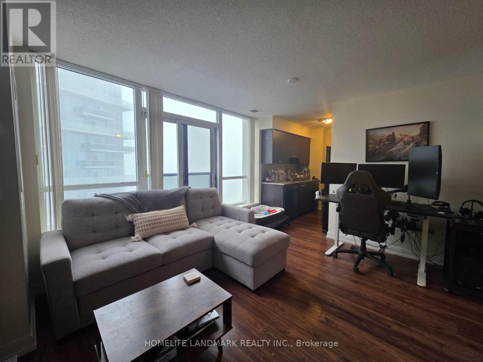 A living room with a grey couch and a wooden coffee table.
