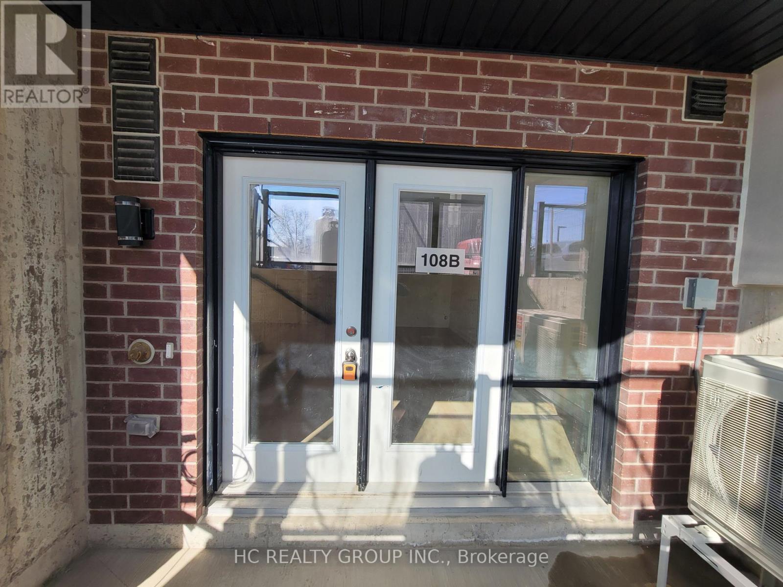 A glass door with a number 108B on it.