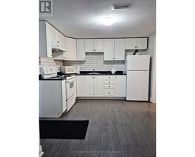 A kitchen with white appliances and cabinets.