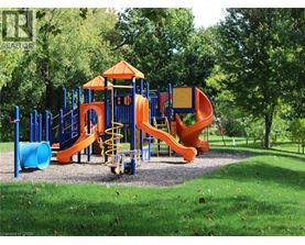 A playground with a blue and orange slide and a yellow staircase.