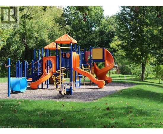 A playground with a blue and orange slide and a yellow staircase.