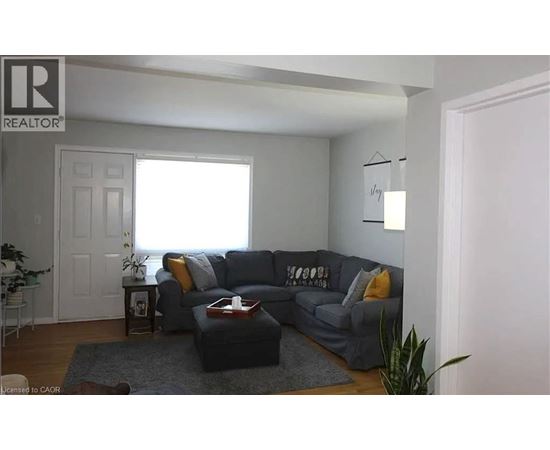 A living room with a grey couch and a coffee table.