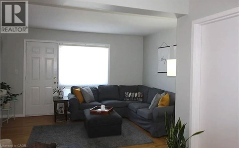 A living room with a grey couch and a coffee table.