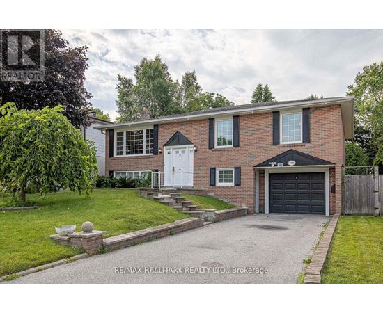 A house with a brick facade and a white garage door is for sale.