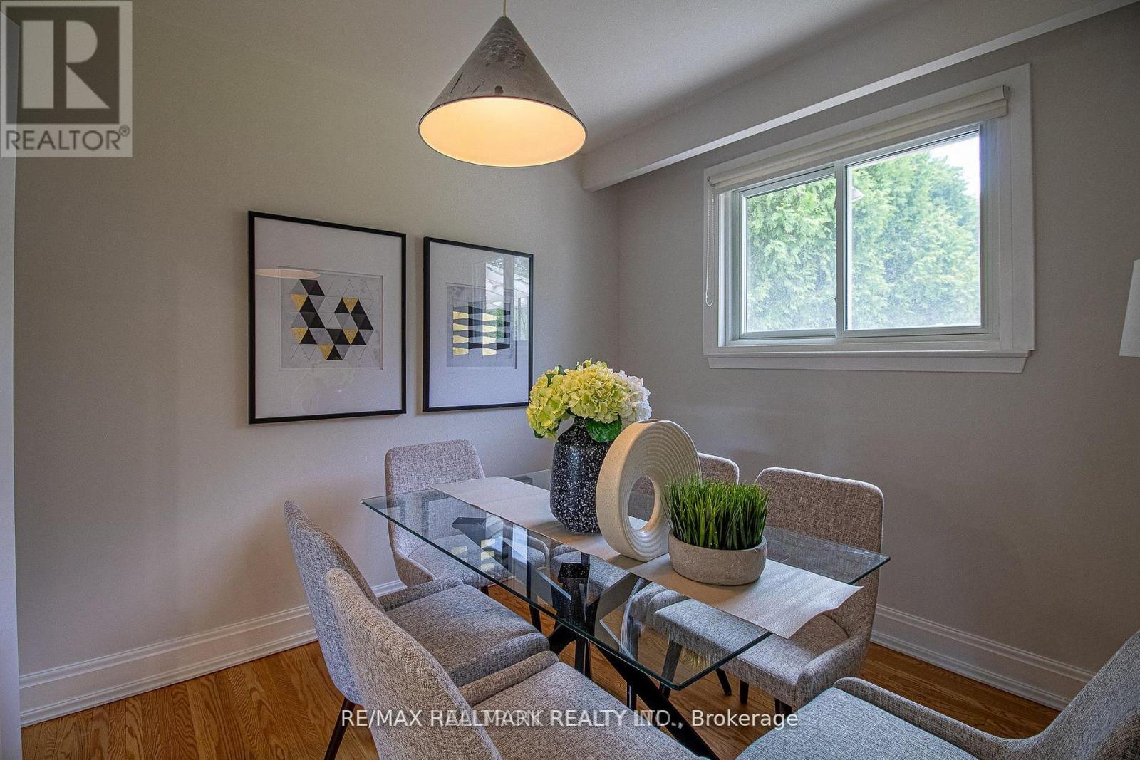 A dining room with a glass table and chairs.