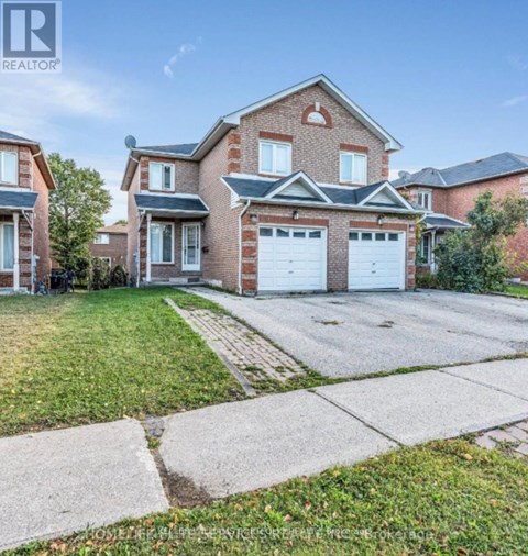 A large brick house with a white garage door is for sale.