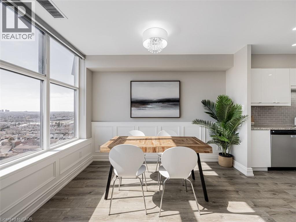 A dining room with a wooden table and white chairs.