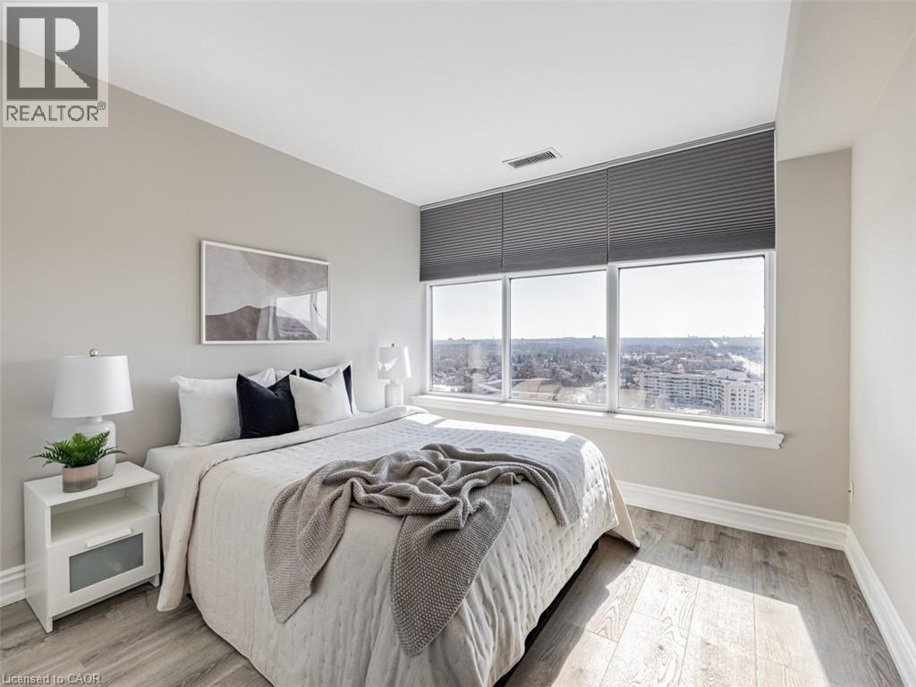 A bedroom with a large bed and a view of the city.