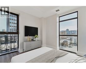 A bedroom with a large bed and a flat screen TV.