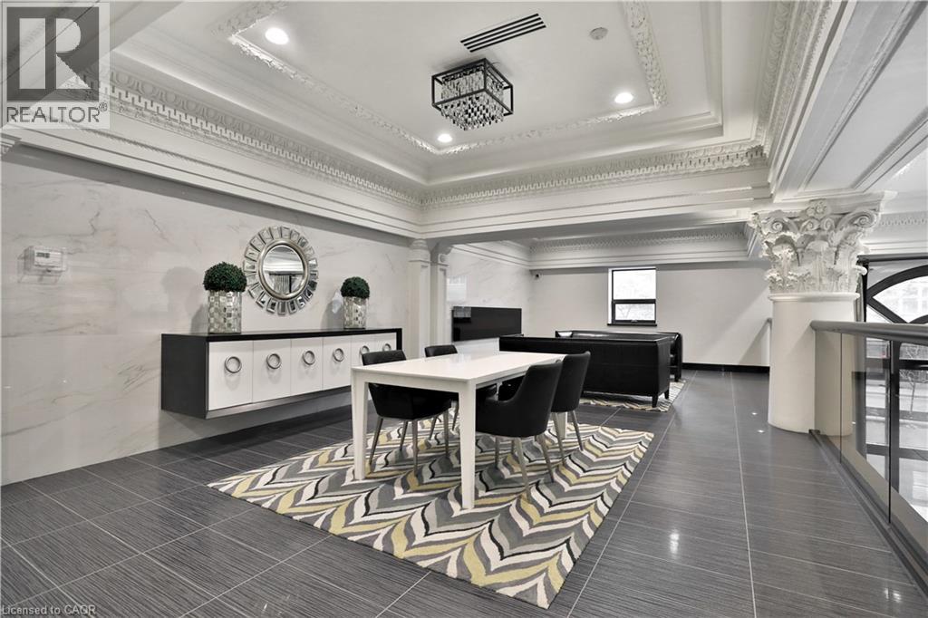 A well-lit, spacious dining area with a marble floor and a large table surrounded by chairs.
