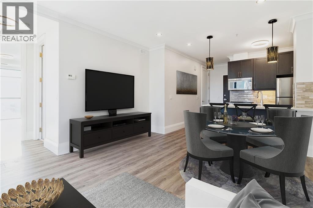 A modern living room with a black television and grey chairs.