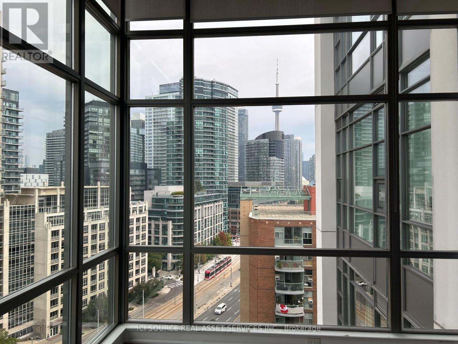 A view from a high-rise building looking out at a busy city street.