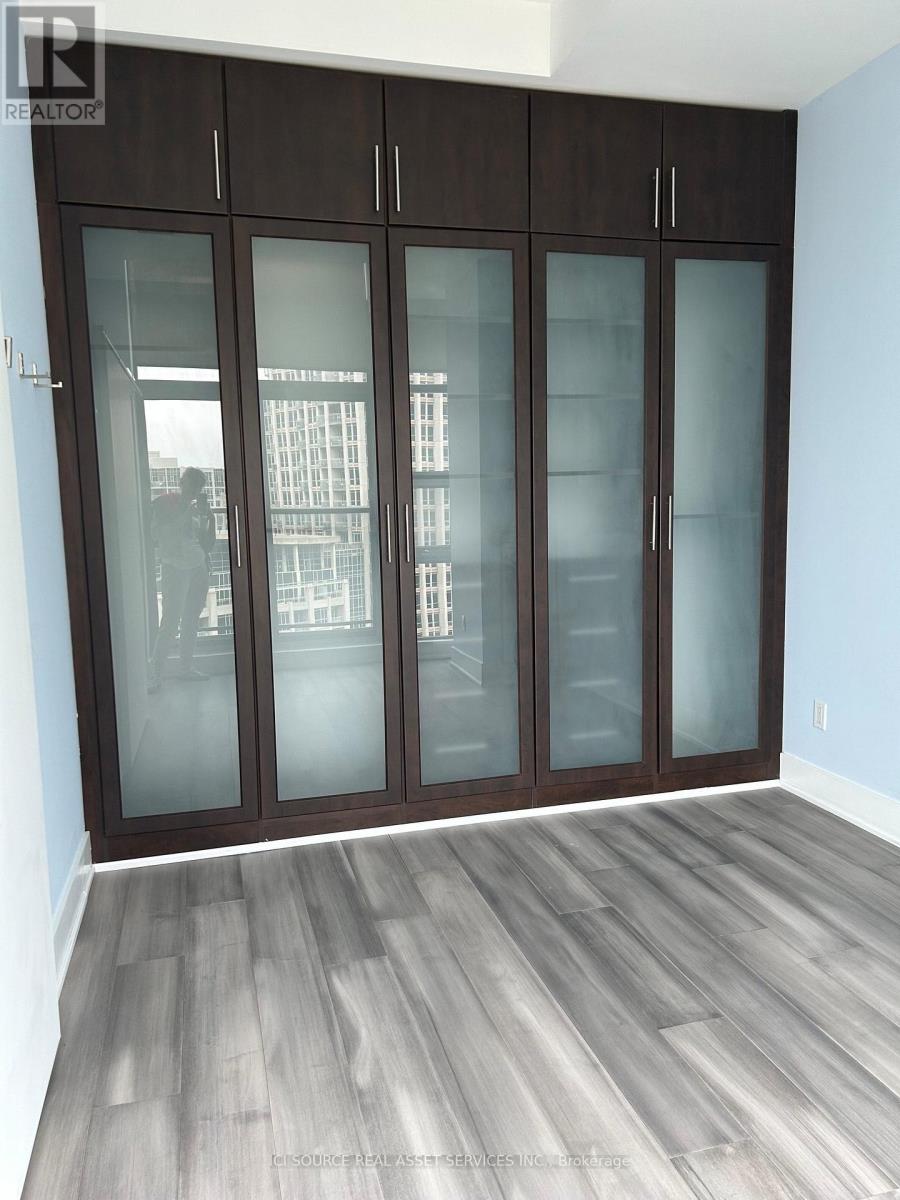 A room with a sliding door and a wooden floor.