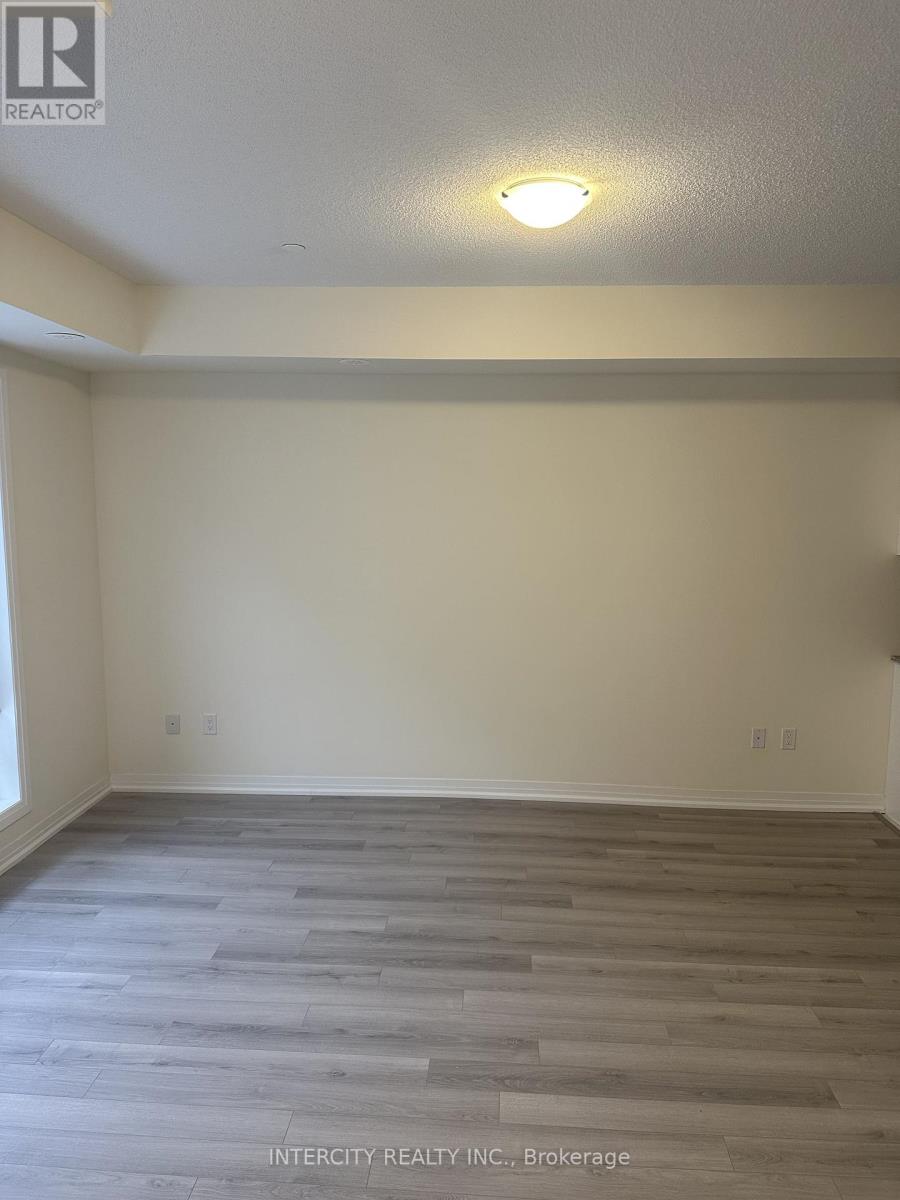 A room with wooden flooring and a light on the ceiling.