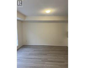 A room with wooden flooring and a light on the ceiling.