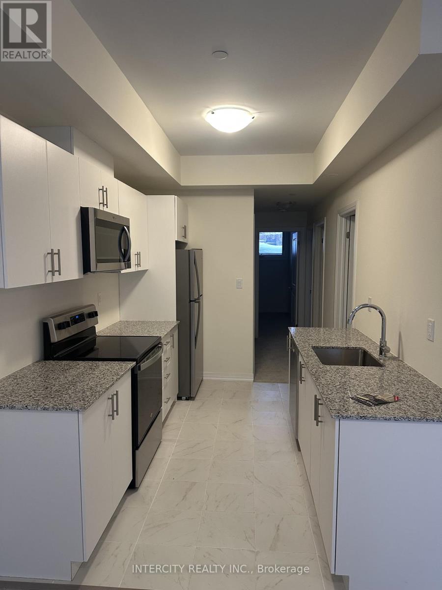 A kitchen with white cabinets and granite countertops.