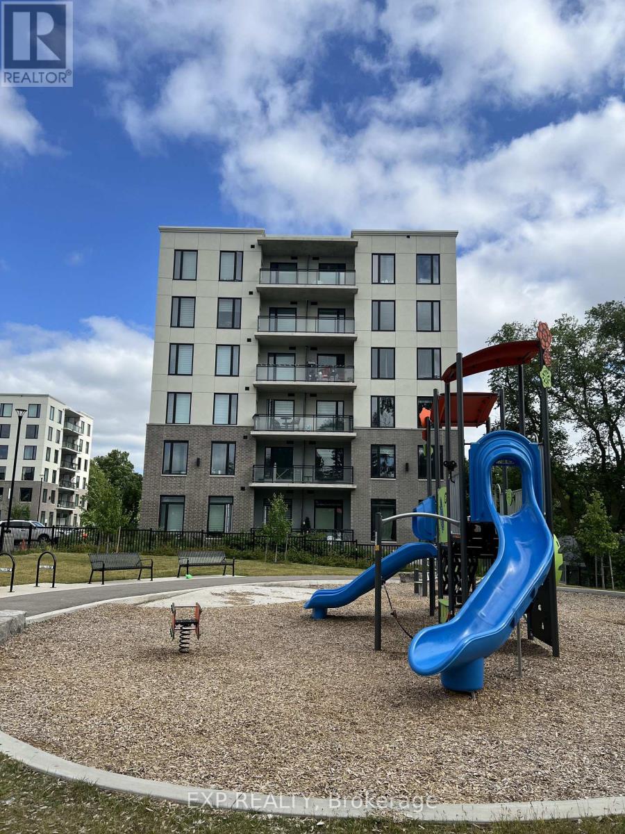 A playground with a blue slide and a building in the background.