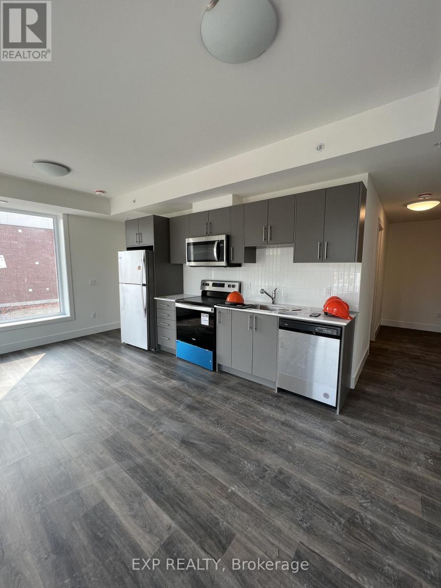 A modern kitchen with grey flooring and a large island.