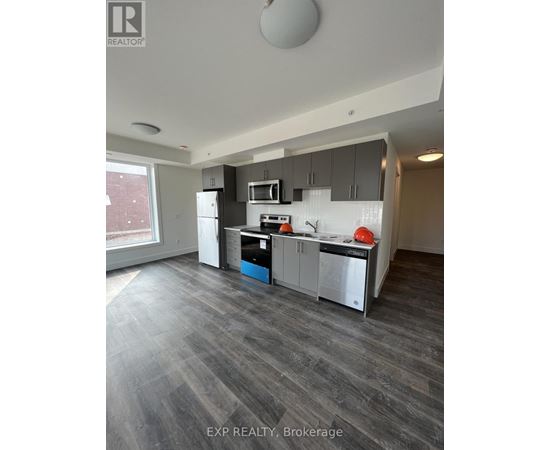 A modern kitchen with grey flooring and a large island.