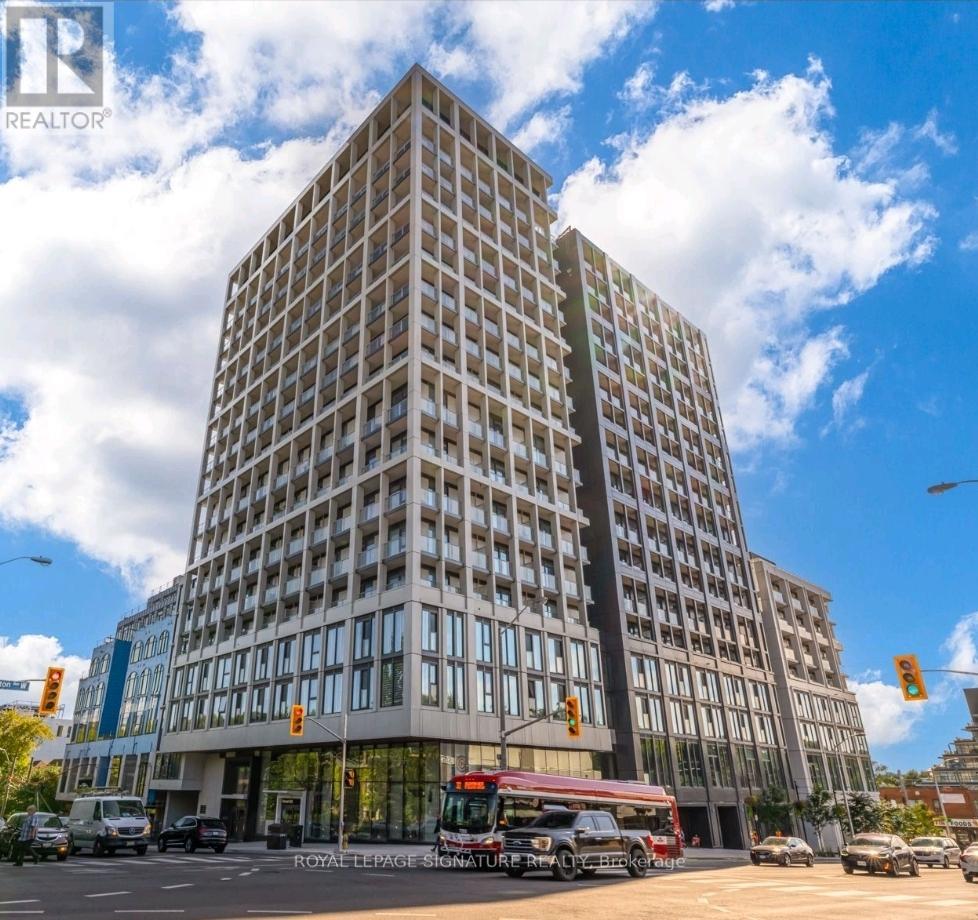 A tall building with a glass facade is the main focus of the image.