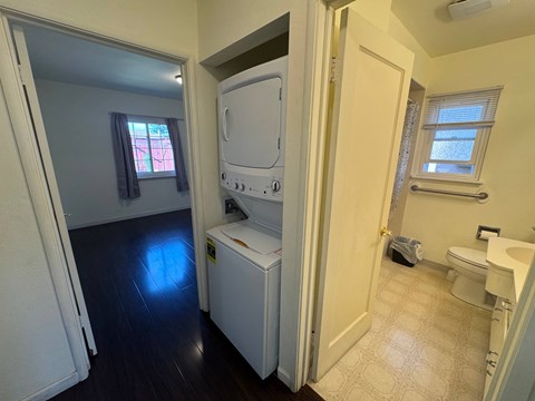 A small laundry room with a washer and dryer.