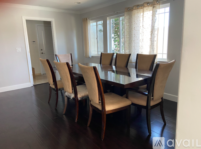 A dining room with a table and chairs.