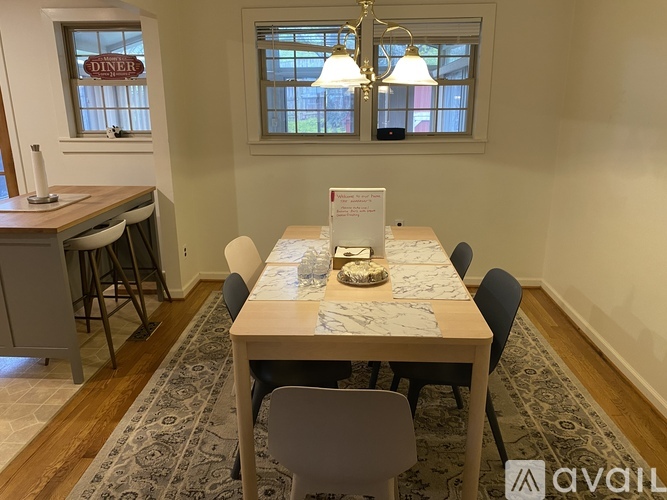 A dining room with a table set for a meal.