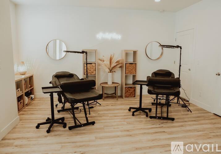 A room with two chairs and a table in the center.