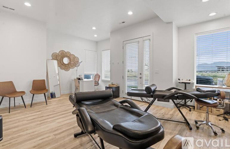 A room with a massage table and chairs.