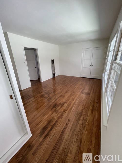 A room with wooden floors and white walls.