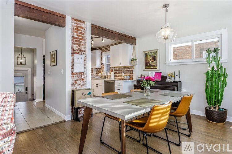 A dining room with a table and chairs.