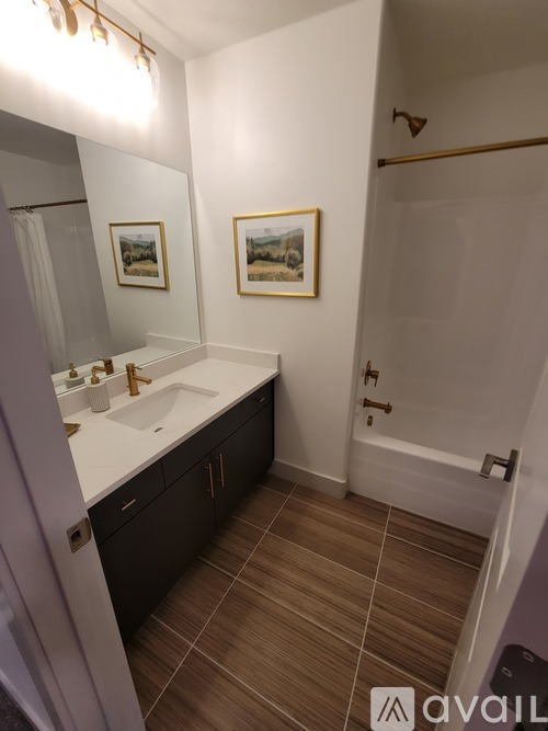 A bathroom with a sink, mirror, and tiled floor.