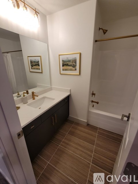 A bathroom with a sink, mirror, and tiled floor.