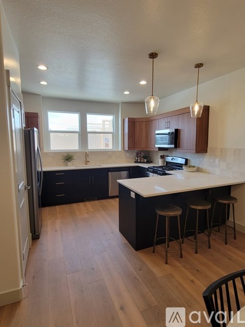 A kitchen with wooden floors and a white countertop.