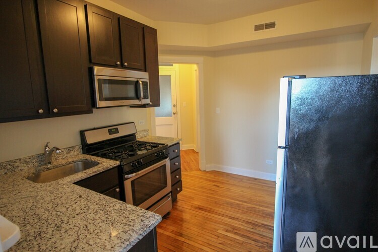 A kitchen with granite countertops and stainless steel appliances.