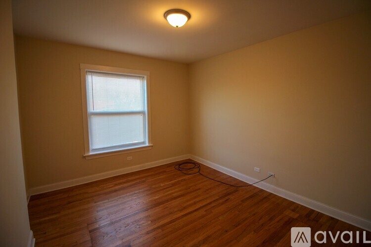 A room with wooden floors and a window.