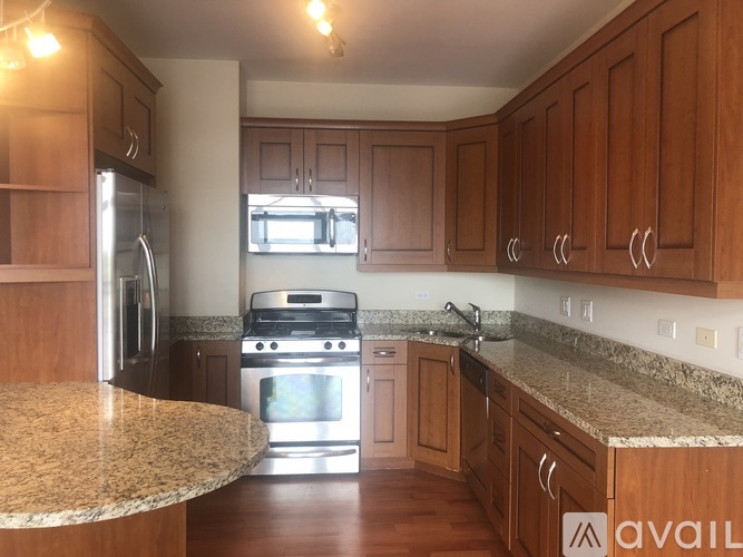 A kitchen with wooden cabinets and granite countertops.