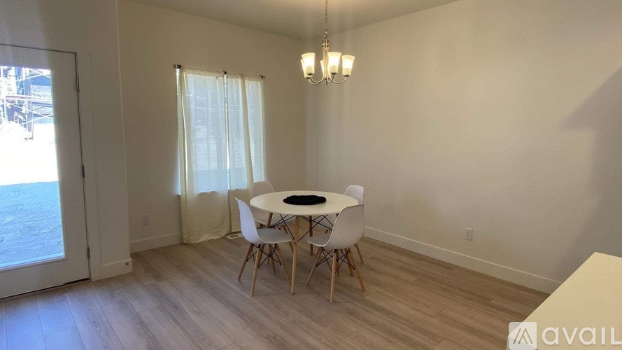 A dining room with a table and chairs.
